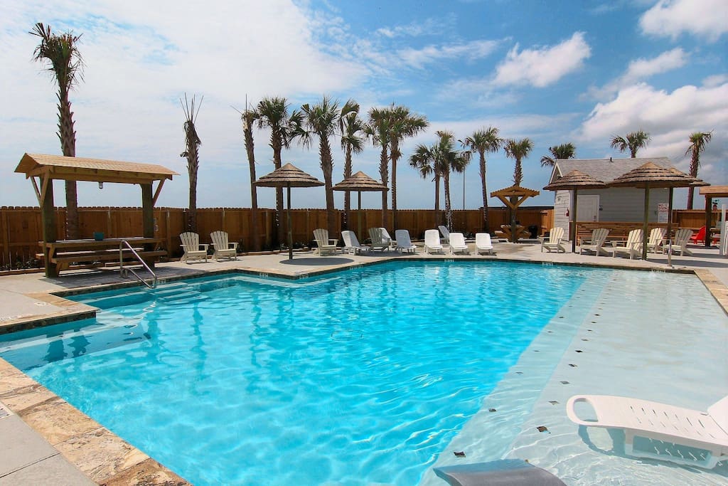 Beautiful pool with barbecue grills and picnic tables