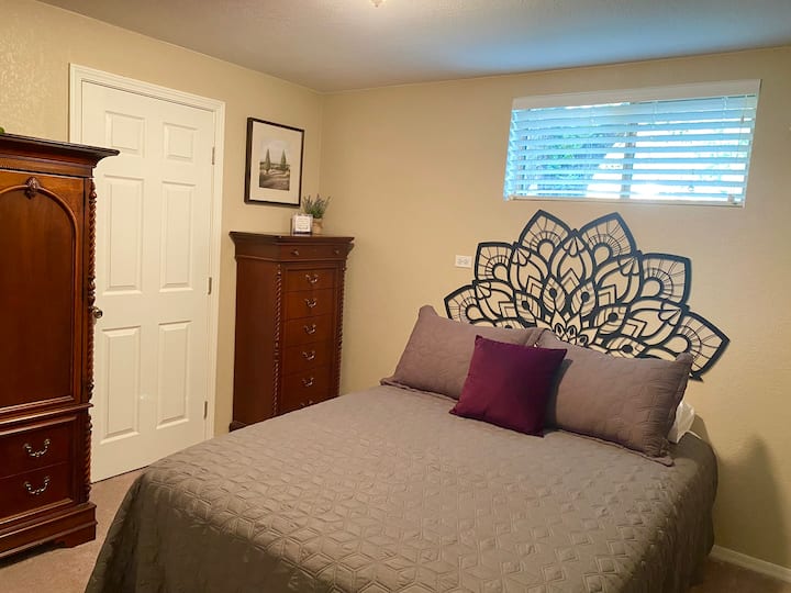 Bedroom 1 is adorned with  elegant cherry wood furniture.