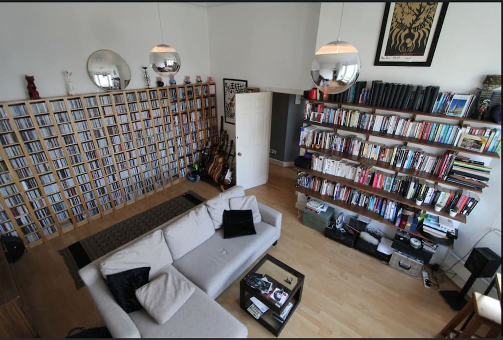 Our front room with high ceilings & single sofa.