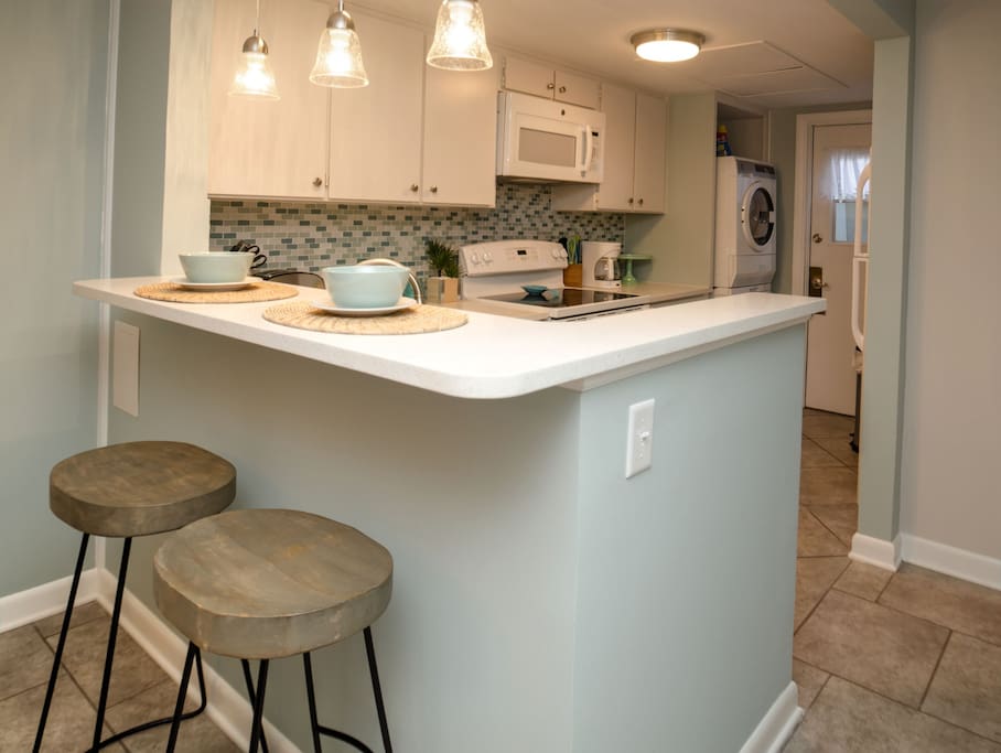 Seating for two at the breakfast bar, quartz counters, well equipped kitchen.