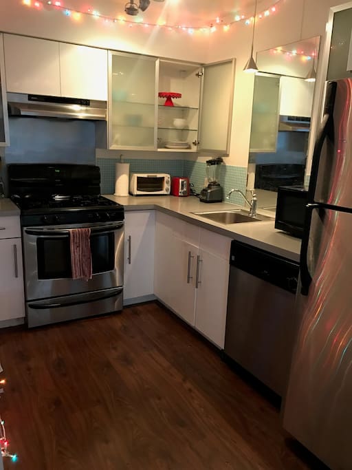 Kitchen features dishwasher, toaster, microwave, stove/oven, fridge, all dinnerware.