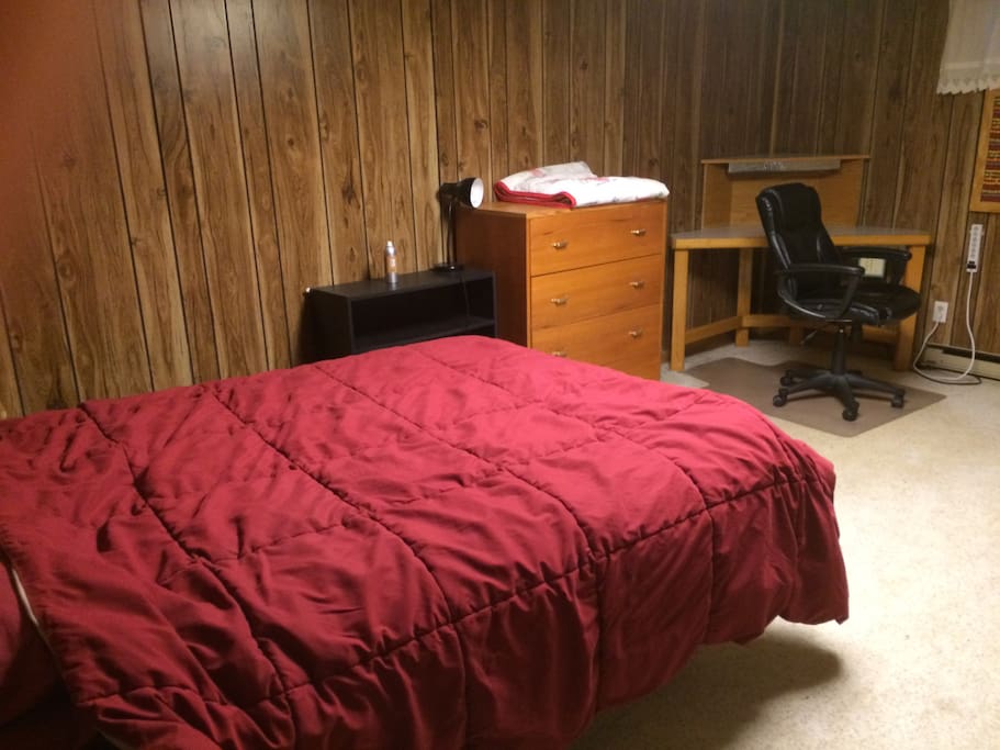 Private bedroom with desk, wifi, and queen size bed.