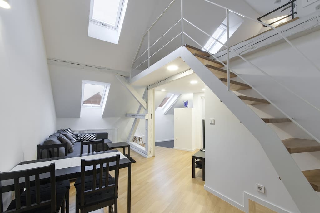 Dining table and a staircase to the upper bonus leisure corner.