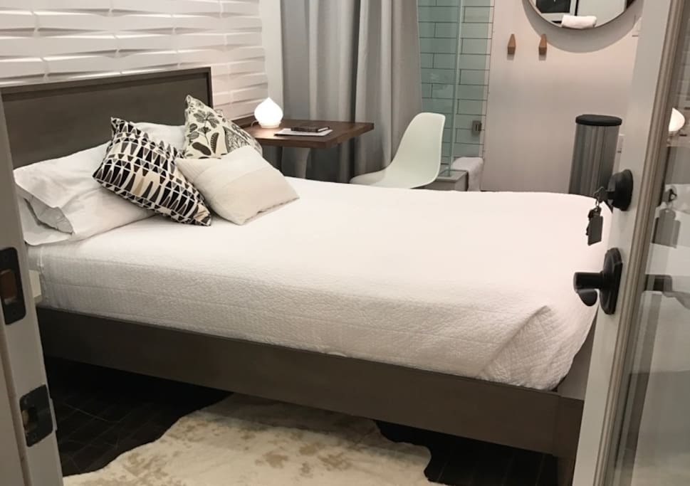 Comfortable queen-size bed with hotel-quality linens.