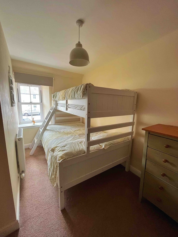 Smaller bedroom with bunk bed - queen bed on bottom, single on top.
