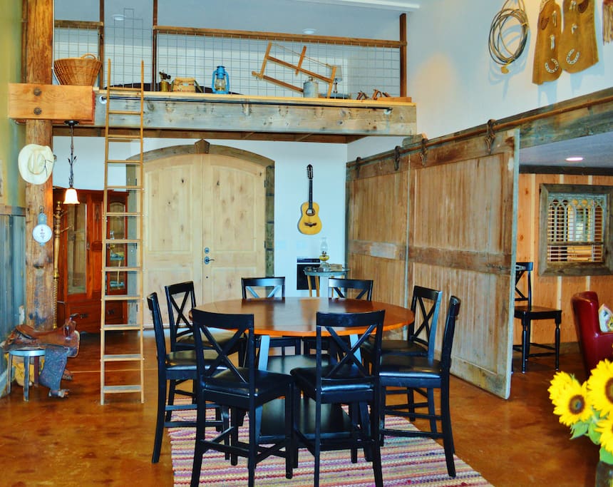sleeping loft with a queen and dining room table