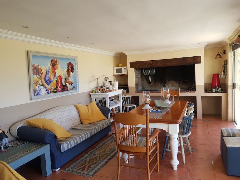 Private entertainment area with tv, fireplace and sliding doors leading onto private garden and patio.