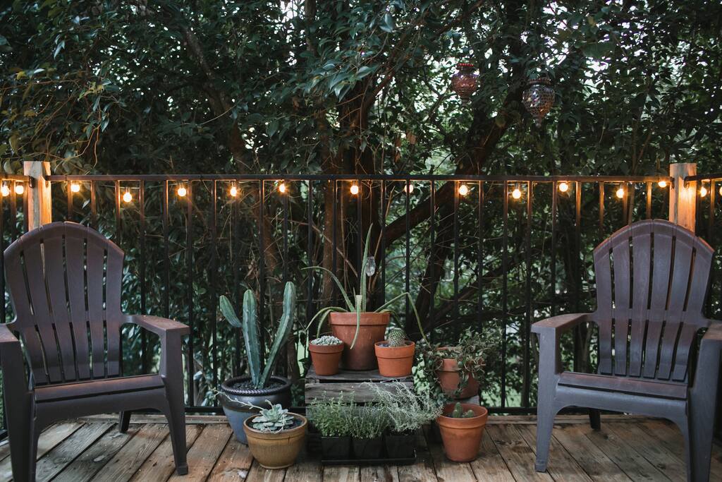 Our patio is perched on a hill surrounded by trees, it feels as if you are in a treehouse. Plenty of space for lounging and dining.