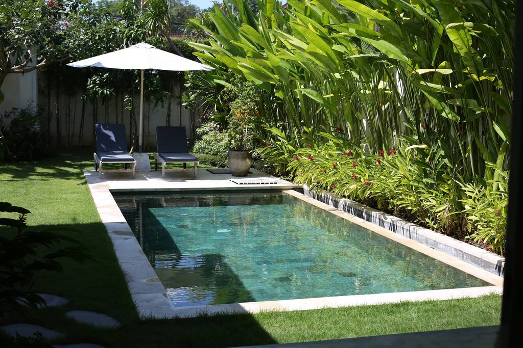The villa overlooks the pool and tropical garden.