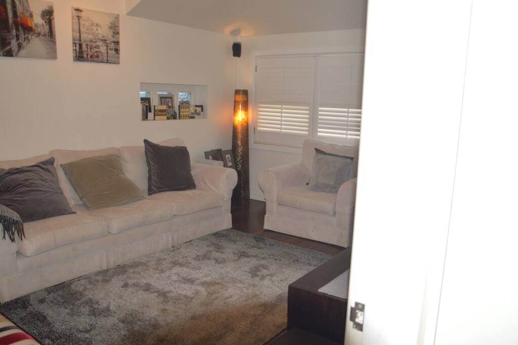 Back living room with TV and laundry