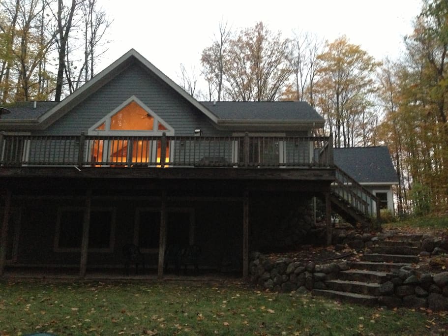 Deck overlooking the fire pit and natural terrain