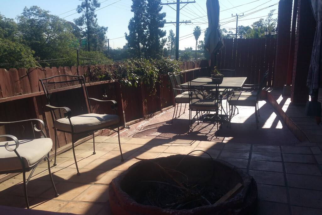There is a large patio with outdoor seating and a fire pit, shared with the resident of the lower unit.