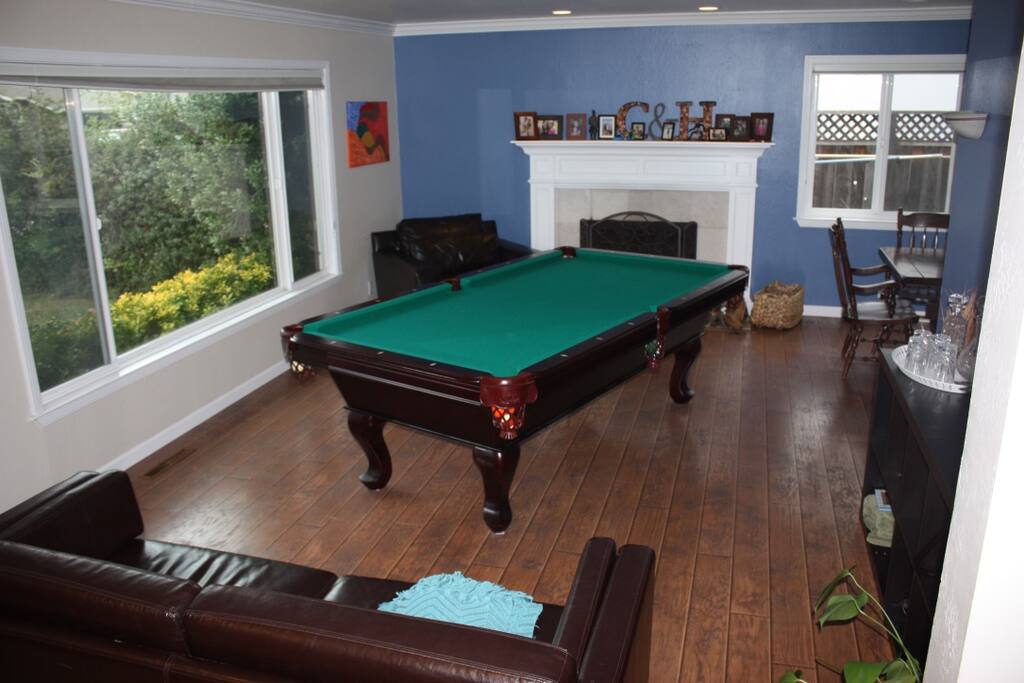 Living room, pool table, fire place.