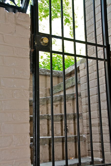 View of front stairs from inside- lock on gate doesn't work, but we can provide a lock if you'd like.
