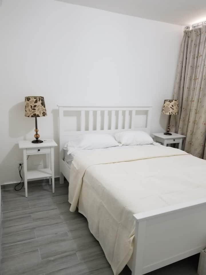 主卧配备一张标准双人床和一间室内卫生间。