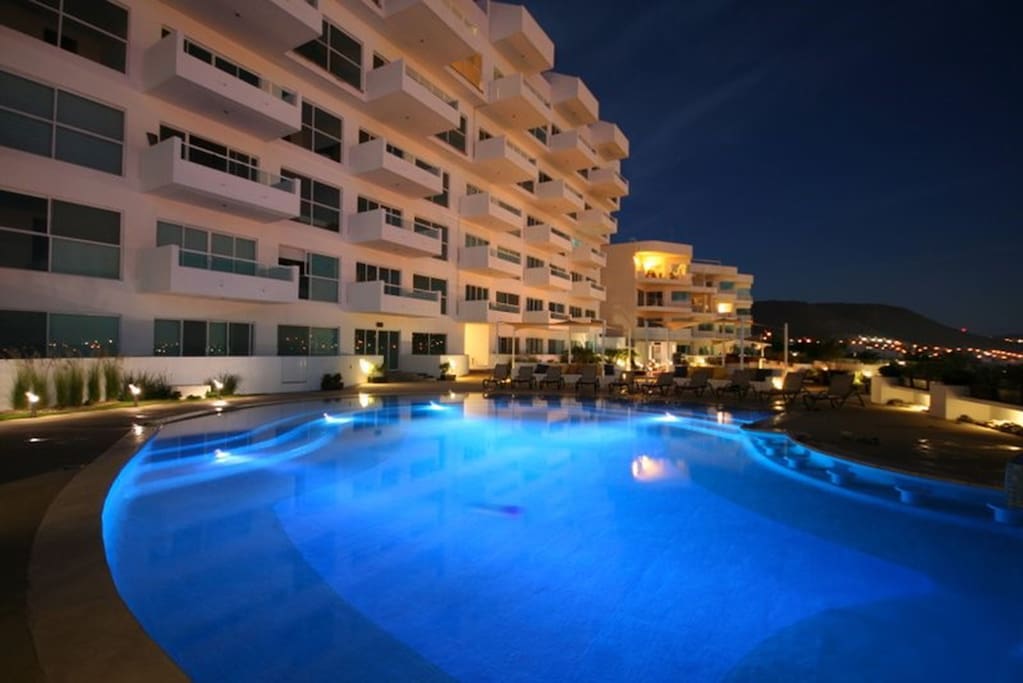 Condo pool and exterior at night