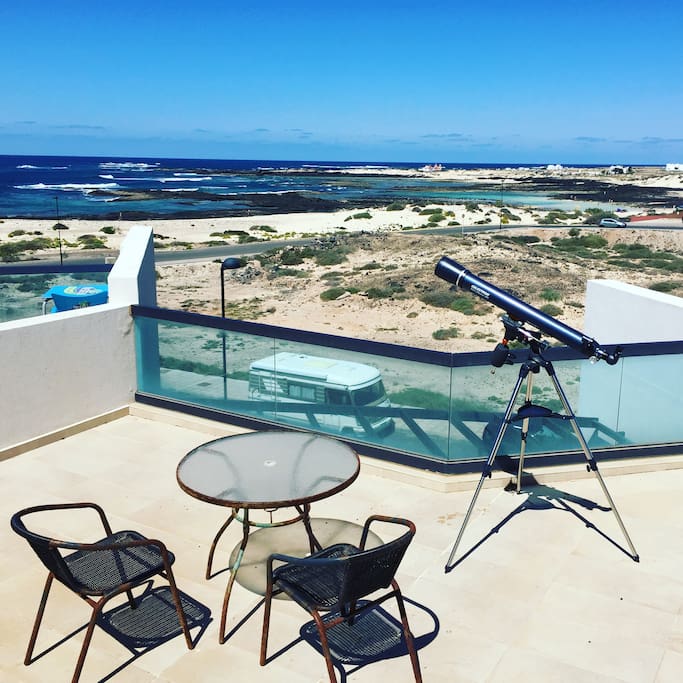 Rooftop Terrace with Sea views, hammock, coffee table & chairs and telescope