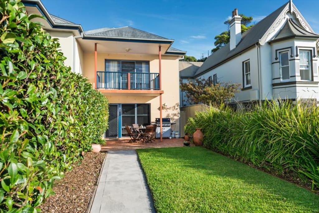 Private entrance with fenced front yard and outdoor seating area