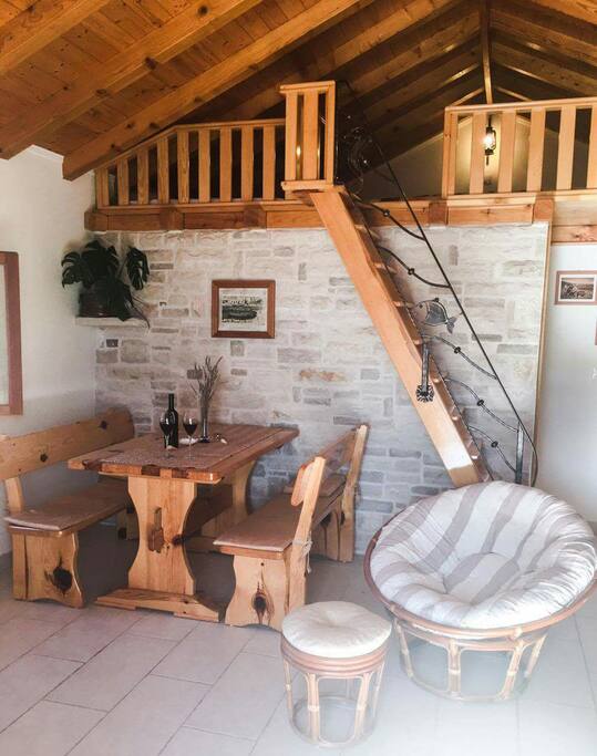 Wooden dining table, stone wall and wooden armchair