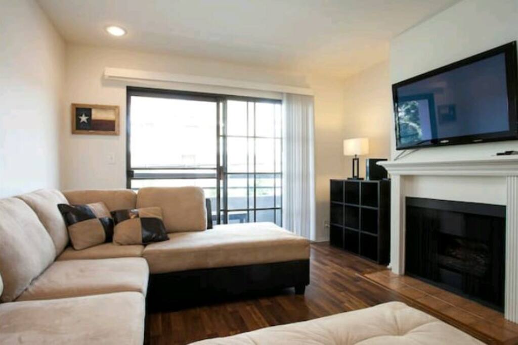 Spacious living room with a big screen TV for your viewing pleasure.