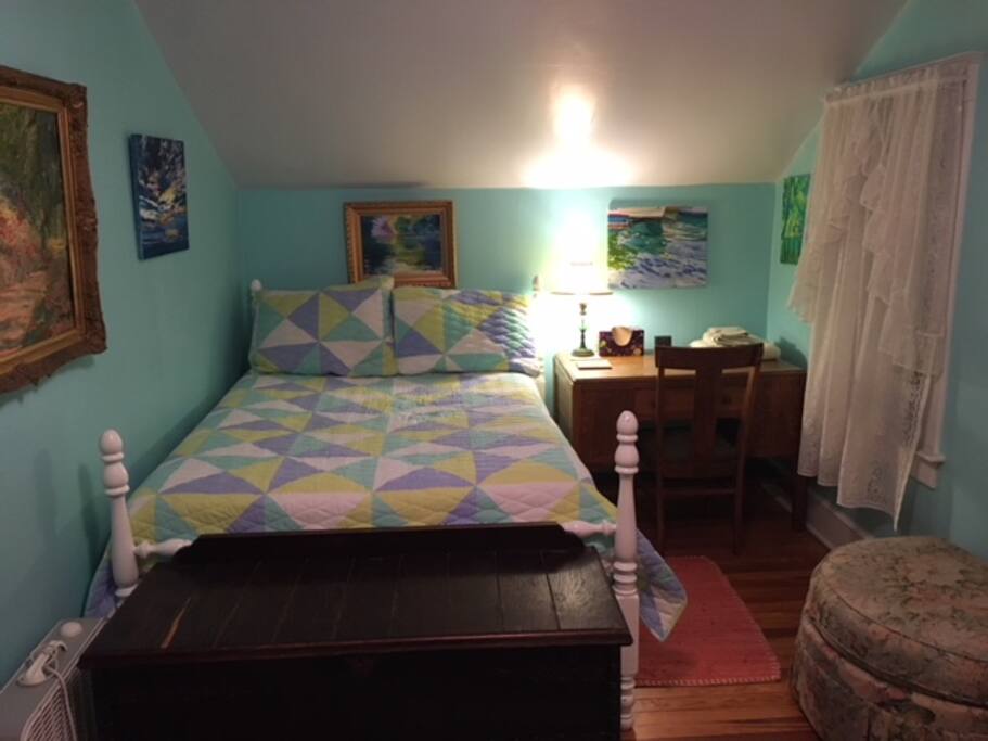 Comfy double bed surrounded by original paintings.