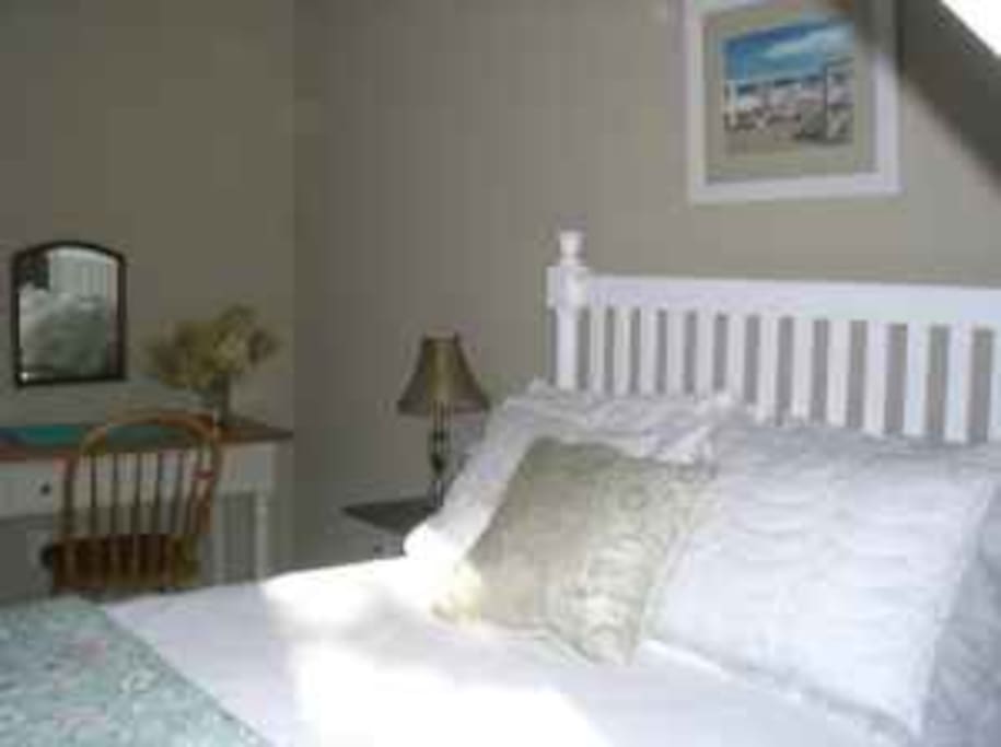 King size bed with desk and walk in closet.