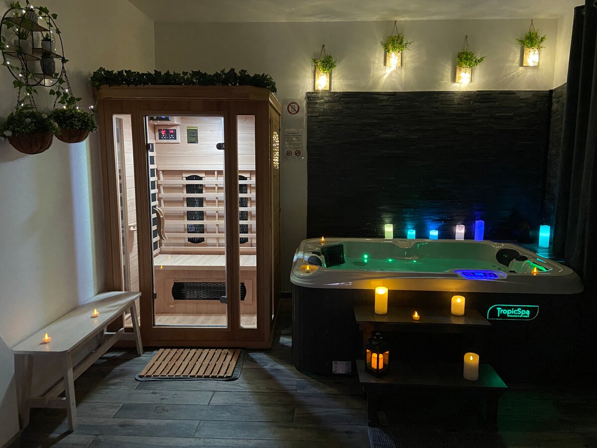 A serene wellness area features a sauna with warm wood accents and a jacuzzi equipped with soft lighting. Candles are strategically placed to create a calming atmosphere, while a small bench offers a spot for relaxation. The overall design promotes a sense of tranquility.