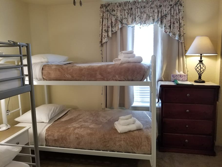 Your shared room features a closet, bureau, several lighting options, a window view, room-darkening curtains, and a 2-person couch.