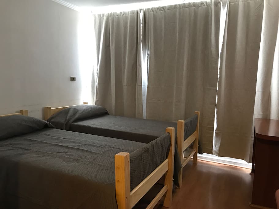 Two beds in studio apartment.