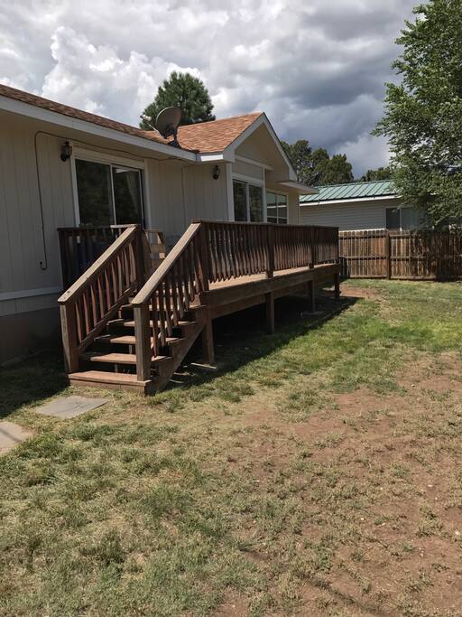 Stairs from deck to backyard. Backyard is completely fenced in.