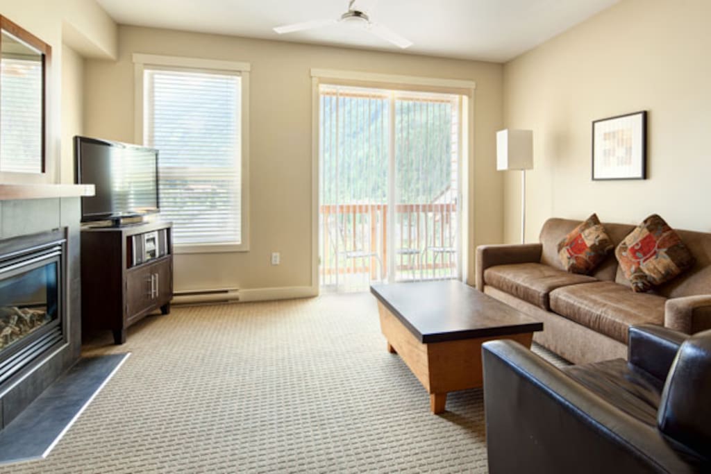 The living area is cozy with modern furnishings and features outdoor access