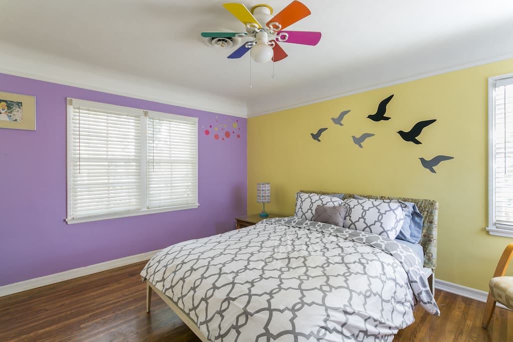 Bright, spacious bedroom with a queen size bed.