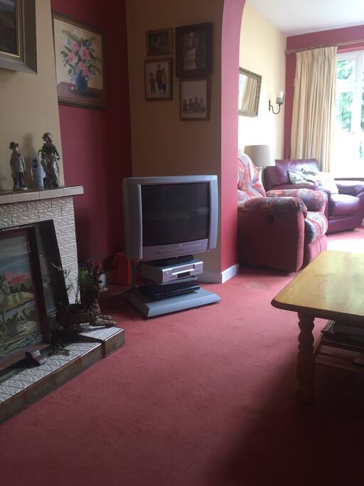 Comfortable spacious living room with cable TVs and DVD player.