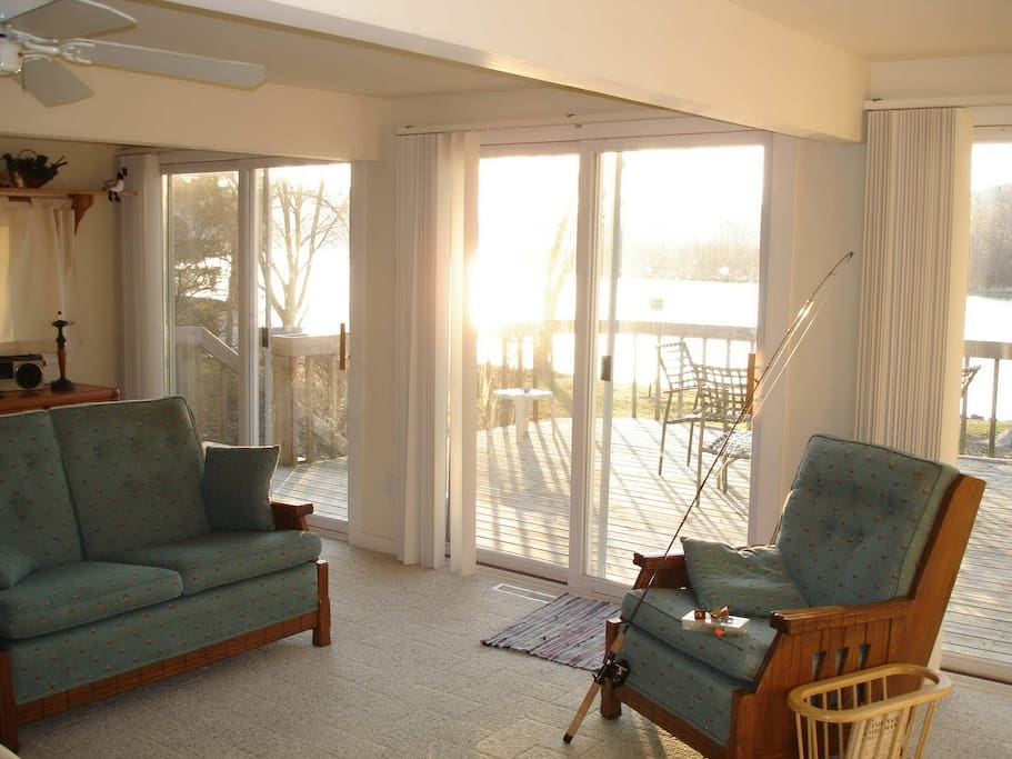 Livingroom with wall of windows looking to water.