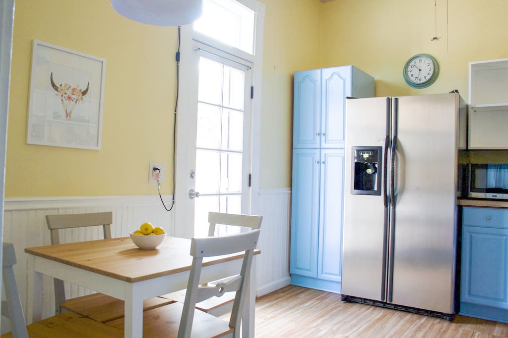 The bright and sunny eat-in kitchen is fully stocked with everything you need to enjoy a meal.