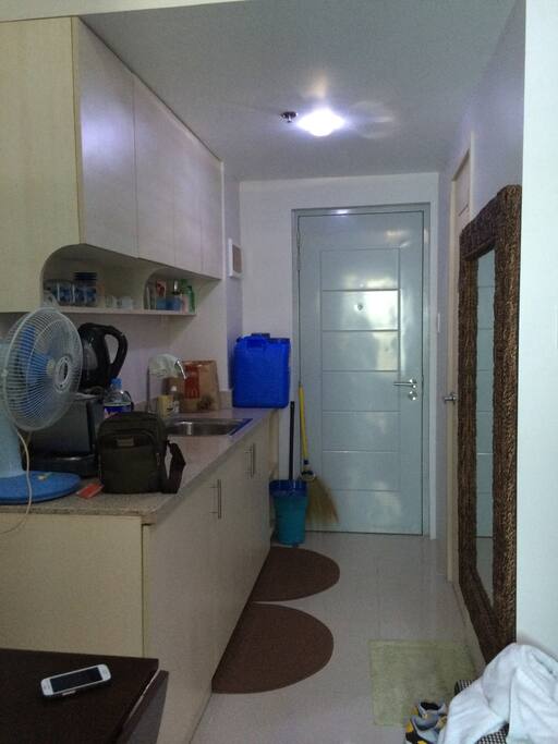 kitchen area with complete utensils, cookrange, fridge, oven toaster