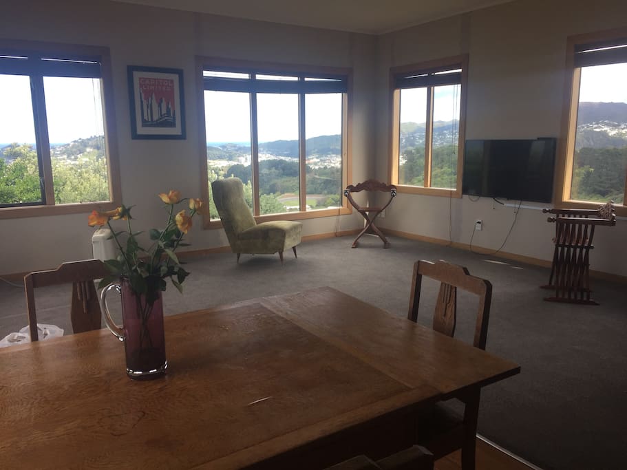 Spacious open plan kitchen, lounge and dining with panoramic views across Cook Strait and Wellington's Green Belt