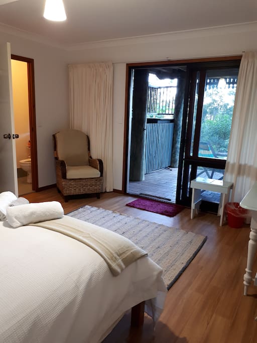Bedroom looks out onto gardens and adjoins toilet and shower area