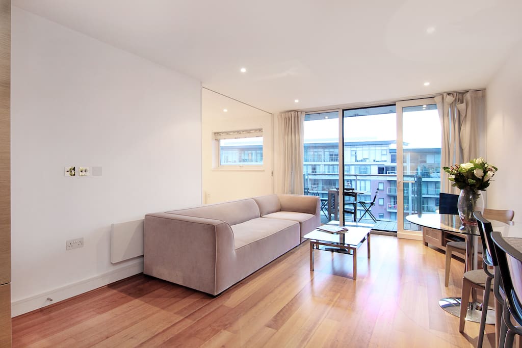 The bright lounge and dining area of this apartment looking out towards the private balcony