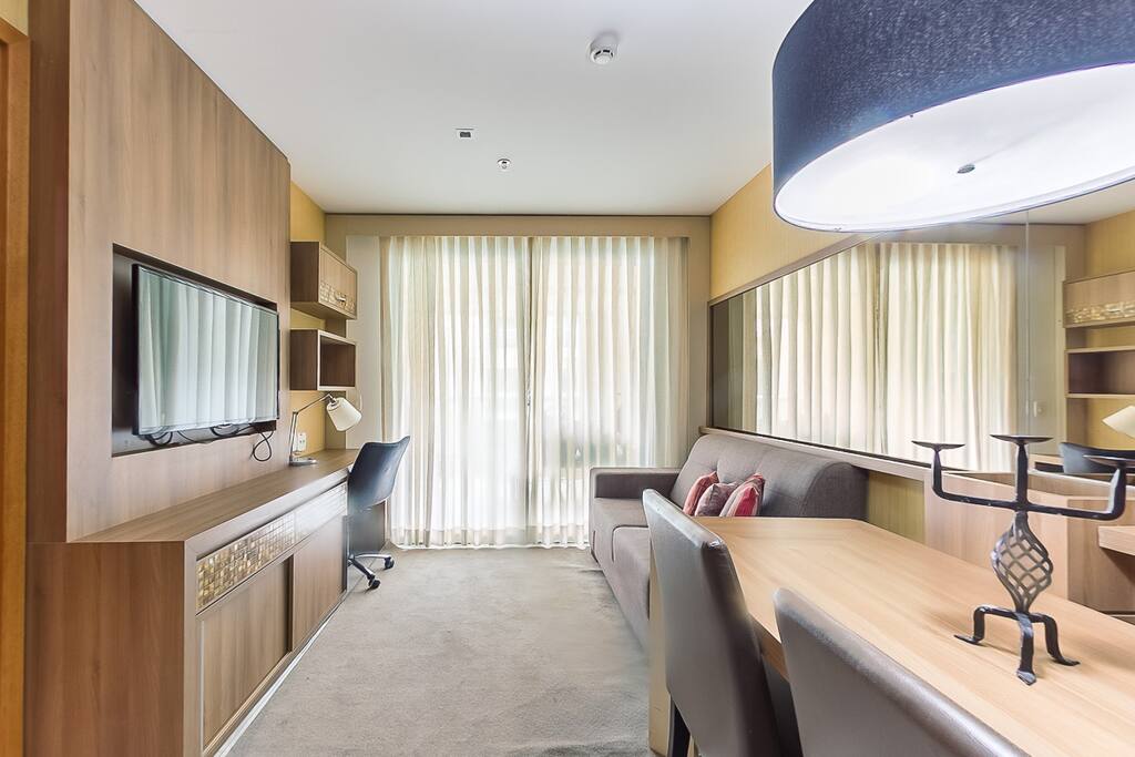 Sala de estar com TV e mesa jantar