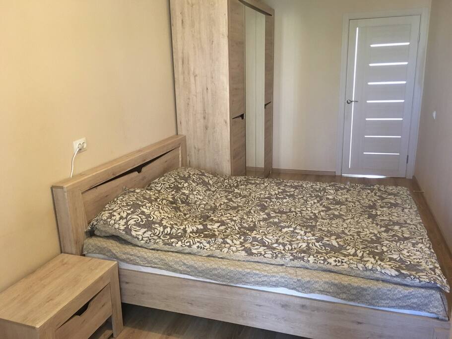 Bedroom with double bed, bedside table, chest of drawers, wardrobe and HD TV