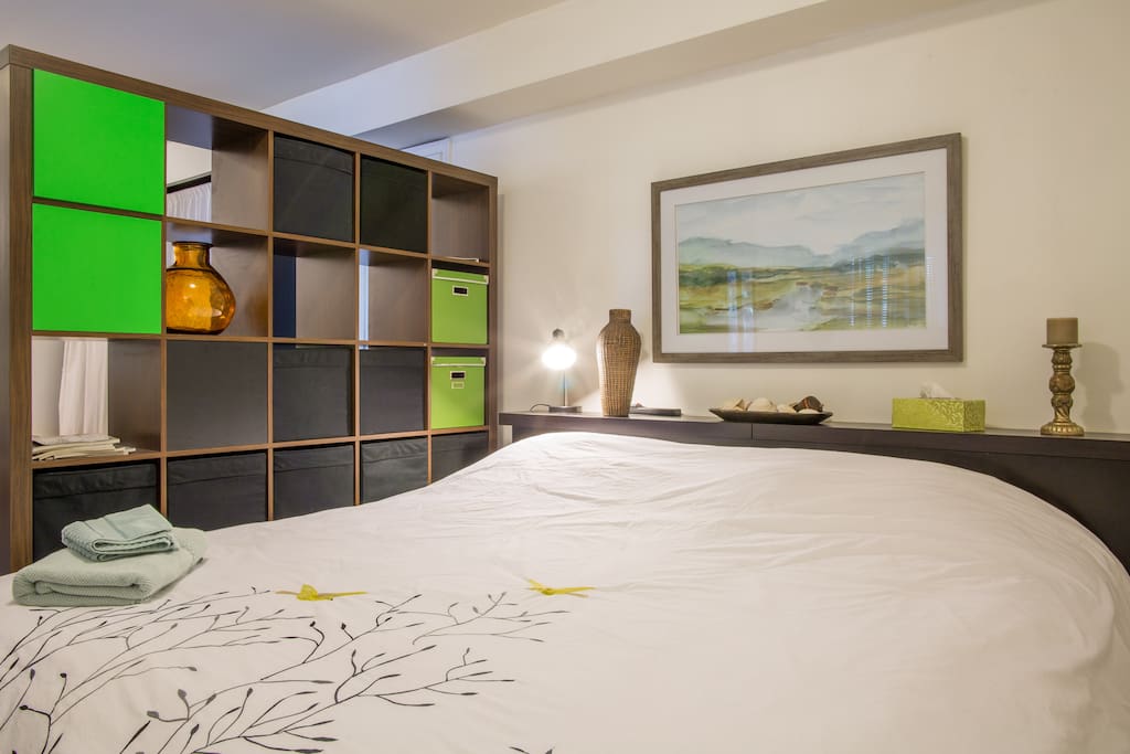 A modern shelving unit provides privacy from the lounging area in your room.