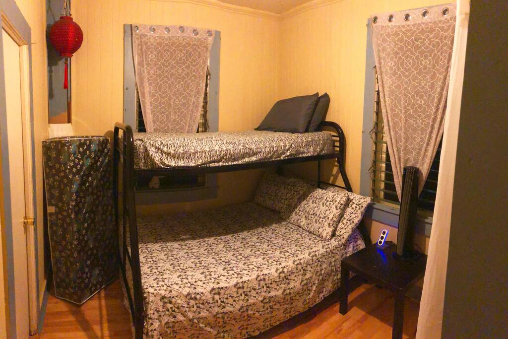 Bedroom #2: This is a semi private room with a curtain that divides it from the living room. It comes with a bunk bed (full size mattress on the bottom and a single mattress top. Also in the room is a foldout futon). This room also has a small closet and a fan.