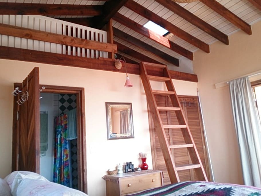 Ocean side loft with ladder steps.