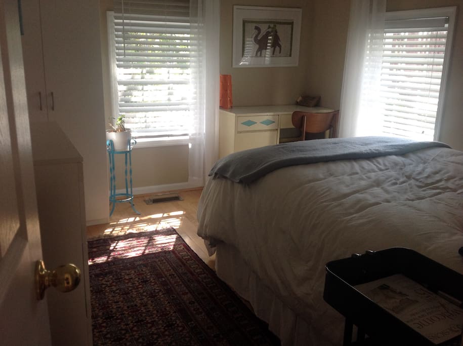 Charming, cozy, quiet and light-filled bedroom with an incredibly luxurious bed.