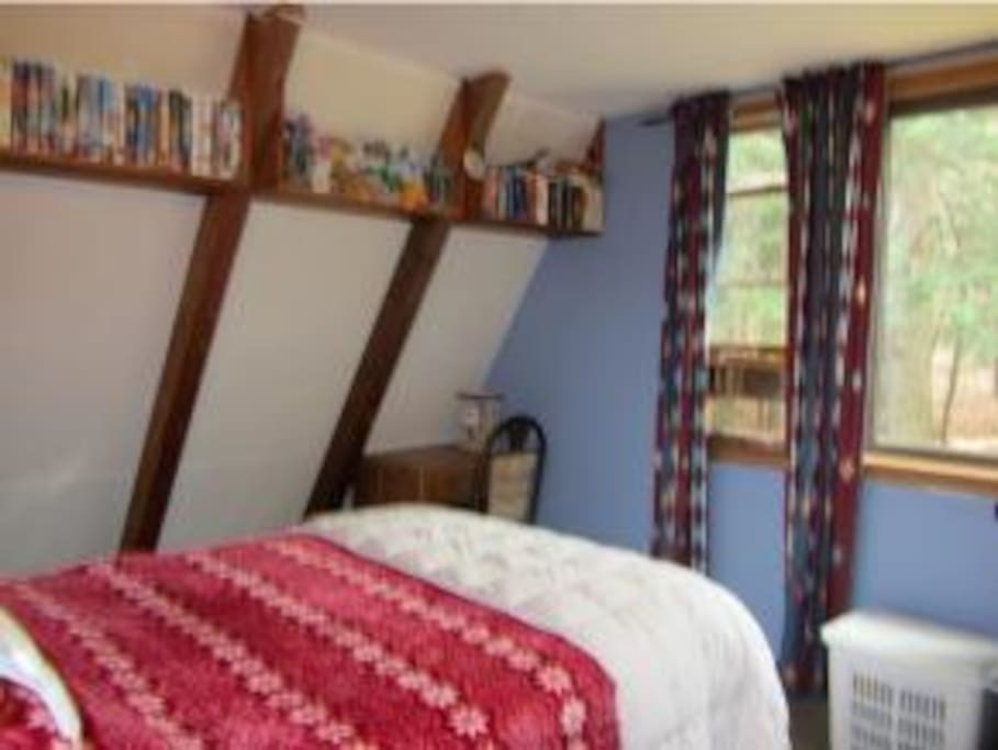 master bedroom w/ large picture window overlooking pond/woods