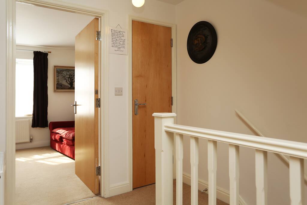 View from the room towards stairs and the other single room.
