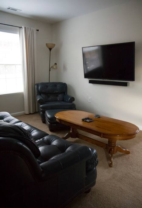 Movie area! Large leather couch, 55" ultra hd tv, sound bar, surround sound speakers, subwoofer, netflix, hulu, amazon prime, and PS3 with a few games.