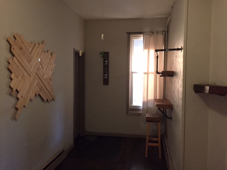 Built in desk area, shelving, clothes hanger, custom artwork and planters all custom made from recycled materials