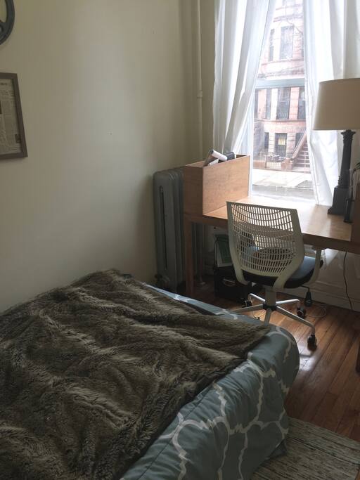 Guest bedroom with desk, overlooking our street